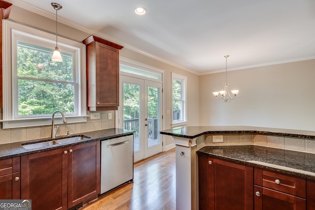 3641 Ridge Towne Dr, Duluth, GA 30096 - kitchen with dishwasher, light wood-style flooring, dark stone countertops, backsplash, and ornamental molding