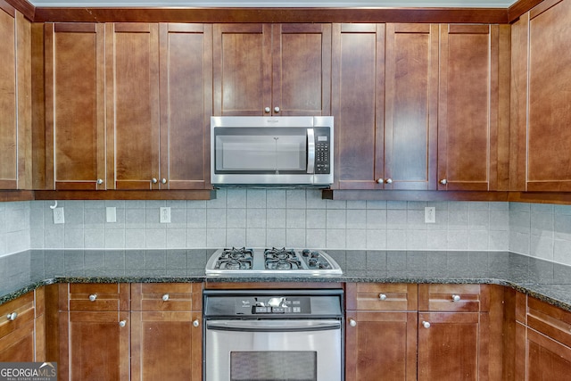 3641 Ridge Towne Dr, Duluth, GA 30096 - kitchen with stainless steel appliances, tasteful backsplash, brown cabinets, and dark stone countertops