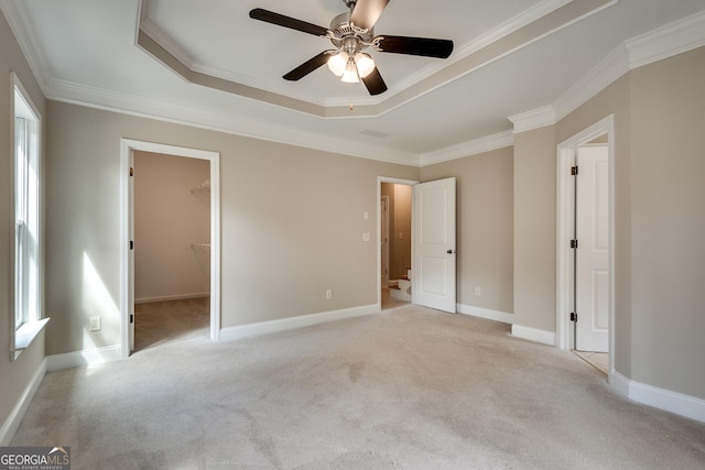 3641 Ridge Towne Dr, Duluth, GA 30096 - unfurnished bedroom with crown molding, light carpet, a tray ceiling, ceiling fan, and a spacious closet