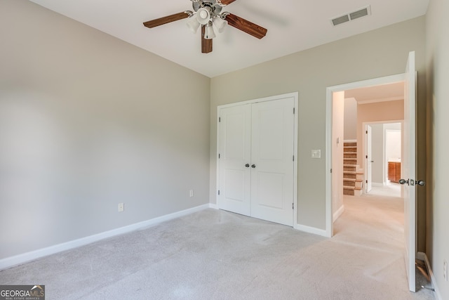 3641 Ridge Towne Dr, Duluth, GA 30096 - unfurnished bedroom featuring light carpet, a closet, and a ceiling fan