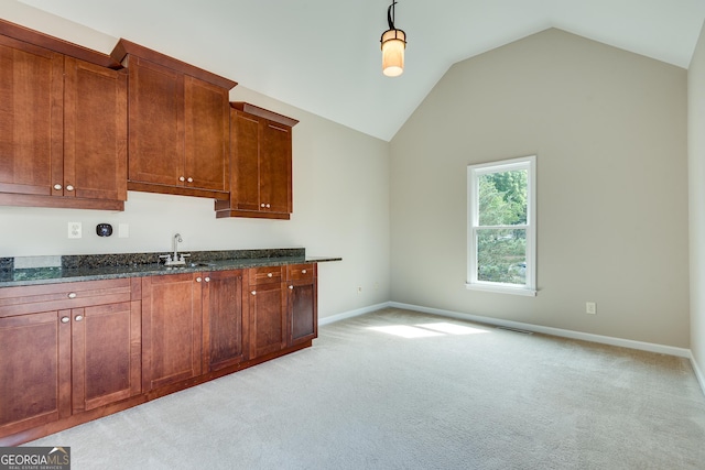 3641 Ridge Towne Dr, Duluth, GA 30096 - kitchen featuring light carpet, vaulted ceiling, dark stone countertops, and decorative light fixtures