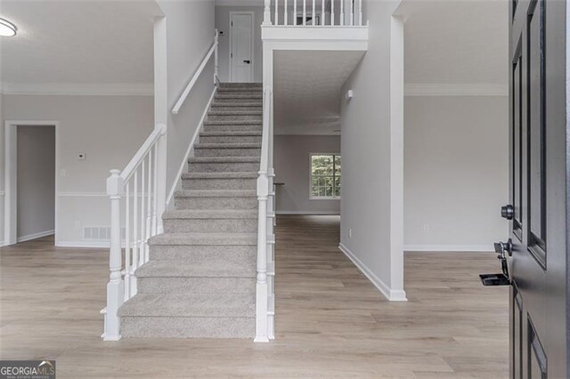 1706 Brandon Lee Way, Marietta, GA 30008 - foyer entrance with light wood-style floors, stairs, baseboards, and ornamental molding