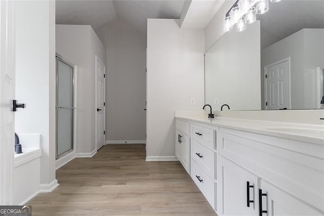 1706 Brandon Lee Way, Marietta, GA 30008 - bathroom with double vanity, wood finished floors, an enclosed shower, and baseboards