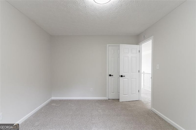 1706 Brandon Lee Way, Marietta, GA 30008 - unfurnished bedroom featuring a textured ceiling, carpet, and baseboards