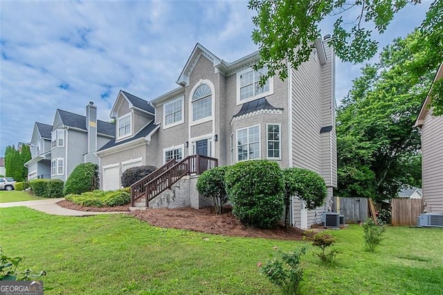 1706 Brandon Lee Way, Marietta, GA 30008 - view of front of house featuring cooling unit, an attached garage, and stucco siding