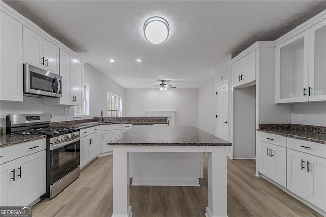 1706 Brandon Lee Way, Marietta, GA 30008 - kitchen with appliances with stainless steel finishes, ceiling fan, light wood finished floors, a sink, and a textured ceiling