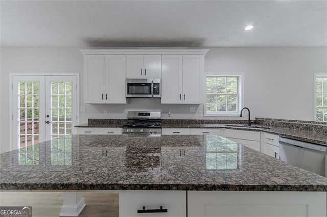1706 Brandon Lee Way, Marietta, GA 30008 - kitchen featuring appliances with stainless steel finishes, a sink, a kitchen island, healthy amount of natural light, and recessed lighting