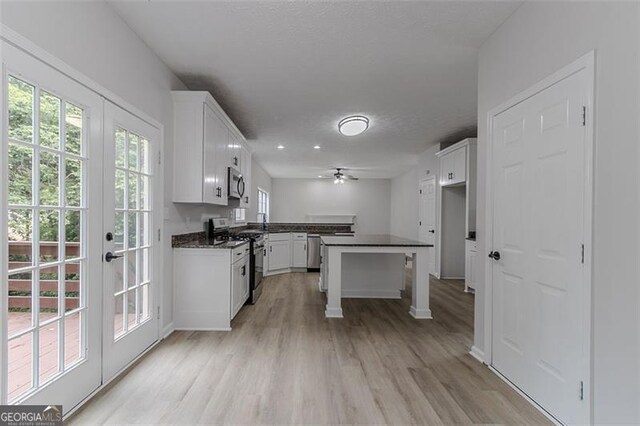 1706 Brandon Lee Way, Marietta, GA 30008 - kitchen featuring appliances with stainless steel finishes, dark countertops, ceiling fan, and white cabinets