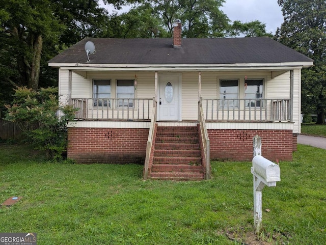 194 Seventh St, Trion, GA 30753 - view of front of house featuring a porch, a front yard, and a chimney