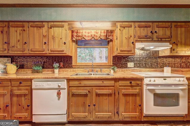 3452 Monica Ln SW, Conyers, GA 30094 - kitchen with white appliances, a sink, under cabinet range hood, backsplash, and brown cabinetry