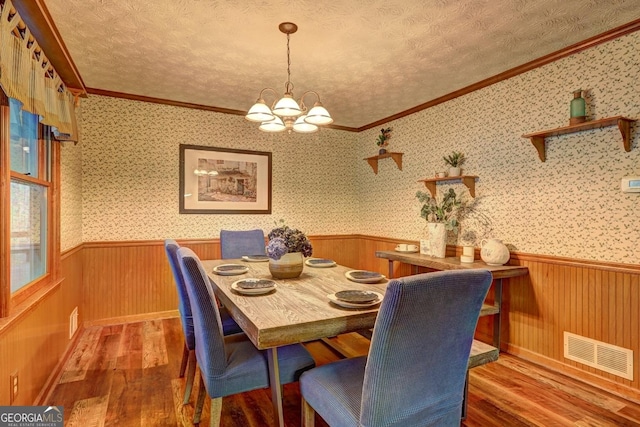 3452 Monica Ln SW, Conyers, GA 30094 - dining room featuring wood finished floors, wainscoting, a chandelier, crown molding, and wood walls
