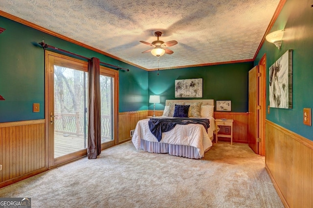 3452 Monica Ln SW, Conyers, GA 30094 - bedroom with wainscoting, wood walls, access to outside, carpet, and crown molding