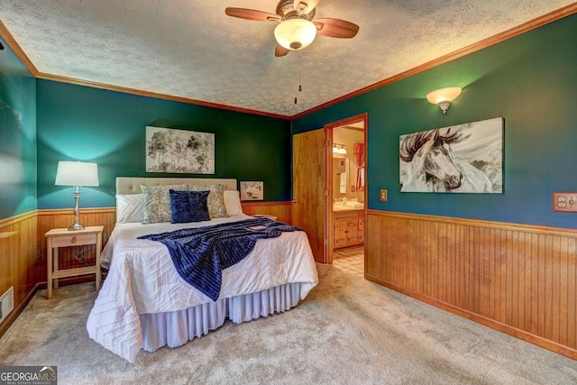 3452 Monica Ln SW, Conyers, GA 30094 - carpeted bedroom featuring wainscoting, wooden walls, a textured ceiling, ensuite bathroom, and ornamental molding