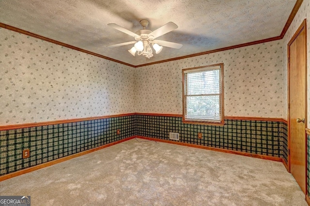 3452 Monica Ln SW, Conyers, GA 30094 - carpeted spare room featuring ornamental molding, wallpapered walls, a wainscoted wall, ceiling fan, and a textured ceiling