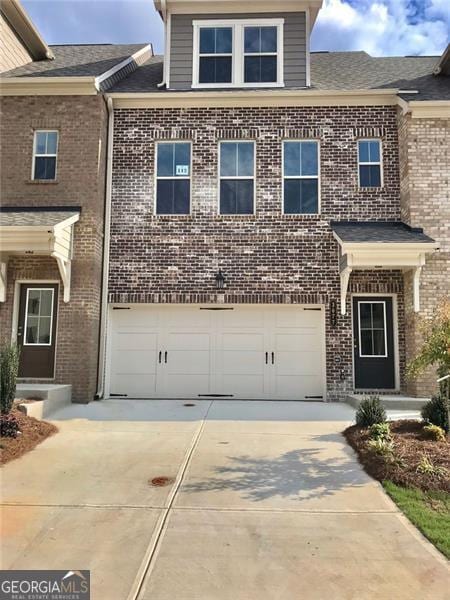 3677 Hidden Valley Cir, Lawrenceville, GA 30044 - view of front of property with concrete driveway, brick siding, and a garage