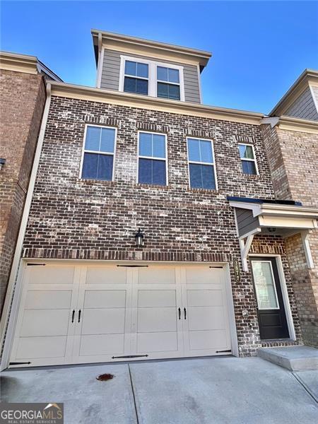 3677 Hidden Valley Cir, Lawrenceville, GA 30044 - traditional-style home featuring concrete driveway, brick siding, and a garage