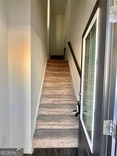 3677 Hidden Valley Cir, Lawrenceville, GA 30044 - stairs featuring wood finished floors and baseboards