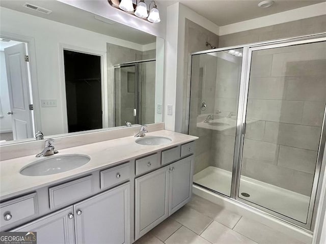 3677 Hidden Valley Cir, Lawrenceville, GA 30044 - bathroom with tile patterned floors, a stall shower, double vanity, and a spacious closet