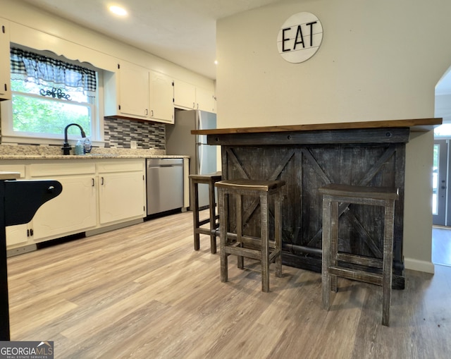 253 Yonah Valley Rd, Cleveland, GA 30528 - kitchen with dishwasher, a sink, white cabinetry, freestanding refrigerator, and recessed lighting