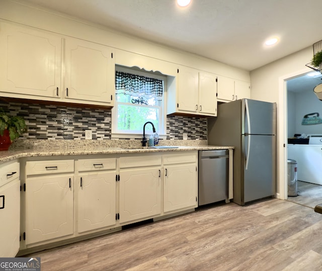 253 Yonah Valley Rd, Cleveland, GA 30528 - kitchen with dishwasher, a sink, freestanding refrigerator, white cabinetry, and backsplash