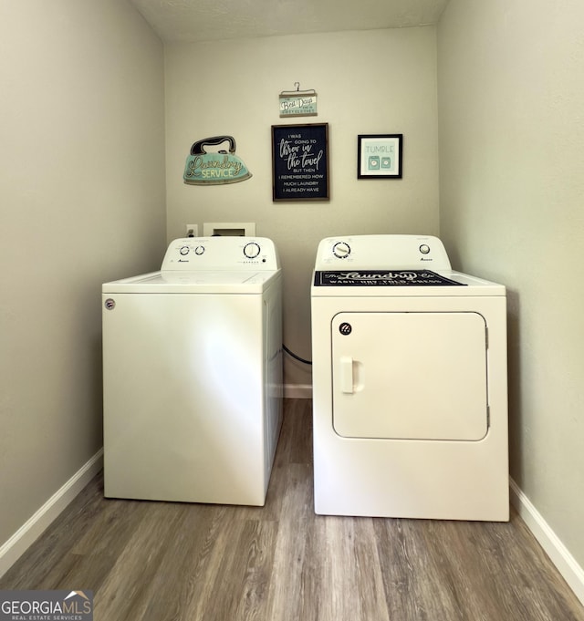 253 Yonah Valley Rd, Cleveland, GA 30528 - laundry area with washer and clothes dryer, wood finished floors, and baseboards