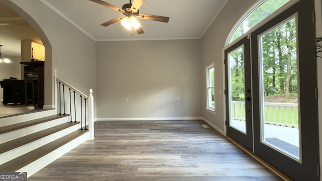 253 Yonah Valley Rd, Cleveland, GA 30528 - foyer featuring french doors, crown molding, wood finished floors, arched walkways, and baseboards