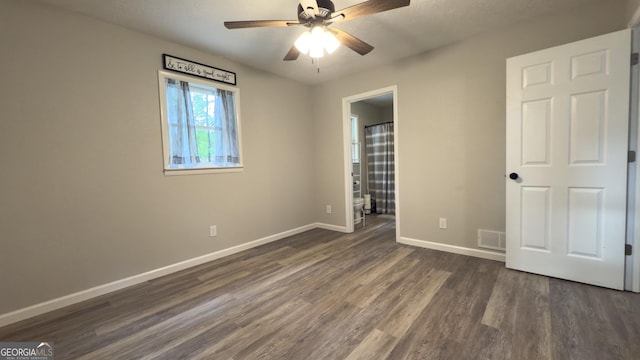 253 Yonah Valley Rd, Cleveland, GA 30528 - unfurnished bedroom with dark wood-style floors, baseboards, ensuite bath, and a ceiling fan