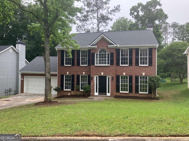 7593 Watson Bay Ct, Stone Mountain, GA 30087 - colonial home with a front yard, an attached garage, driveway, and brick siding