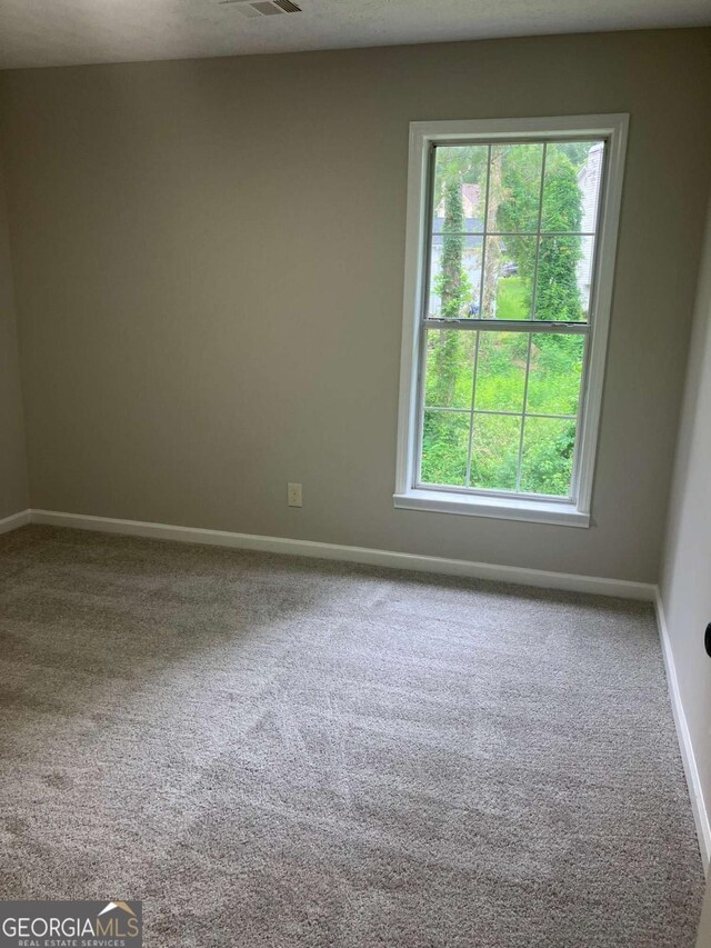7593 Watson Bay Ct, Stone Mountain, GA 30087 - carpeted empty room featuring healthy amount of natural light
