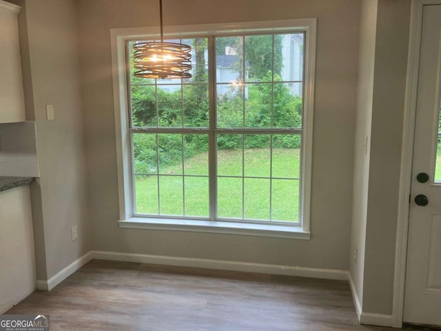 7593 Watson Bay Ct, Stone Mountain, GA 30087 - unfurnished dining area featuring light wood finished floors and a chandelier