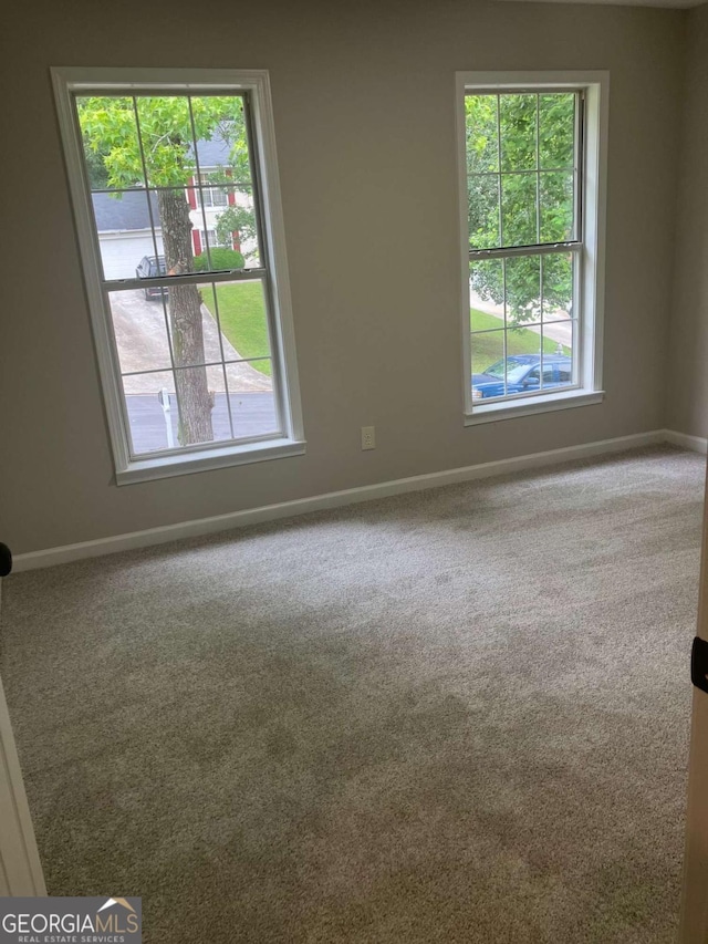 7593 Watson Bay Ct, Stone Mountain, GA 30087 - carpeted empty room with plenty of natural light