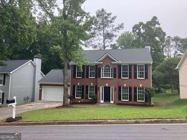 7593 Watson Bay Ct, Stone Mountain, GA 30087 - colonial home with a garage, concrete driveway, a front yard, brick siding, and a chimney