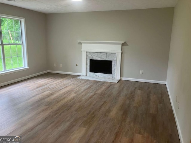 7593 Watson Bay Ct, Stone Mountain, GA 30087 - unfurnished living room with dark wood finished floors, a premium fireplace, and a textured ceiling