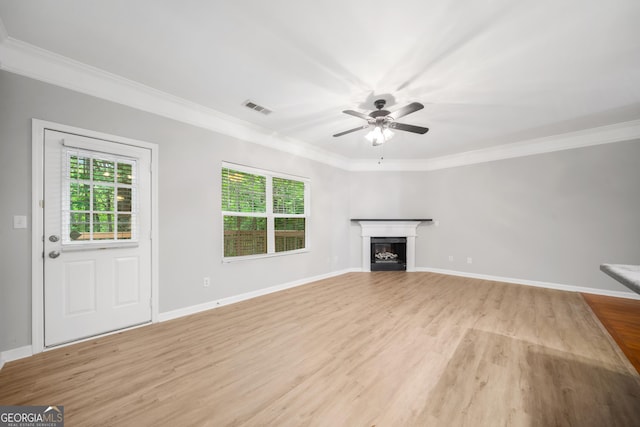 5057 Lower Elm St, Atlanta, GA 30349 - unfurnished living room featuring healthy amount of natural light, light wood finished floors, ornamental molding, ceiling fan, and a fireplace