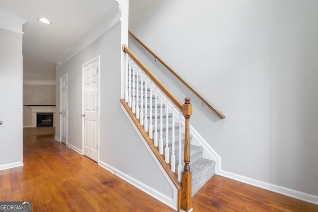 5057 Lower Elm St, Atlanta, GA 30349 - stairs featuring crown molding, wood finished floors, baseboards, a fireplace, and recessed lighting
