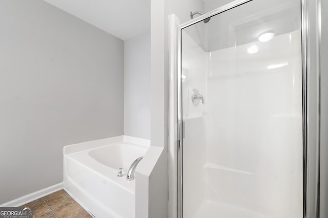 5057 Lower Elm St, Atlanta, GA 30349 - bathroom featuring a shower stall, a bath, and baseboards