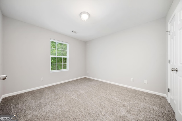 5057 Lower Elm St, Atlanta, GA 30349 - unfurnished room with carpet floors and baseboards
