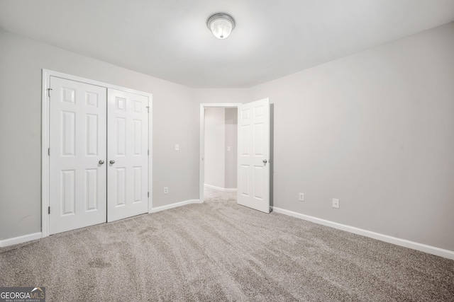 5057 Lower Elm St, Atlanta, GA 30349 - unfurnished bedroom featuring carpet flooring, baseboards, and a closet