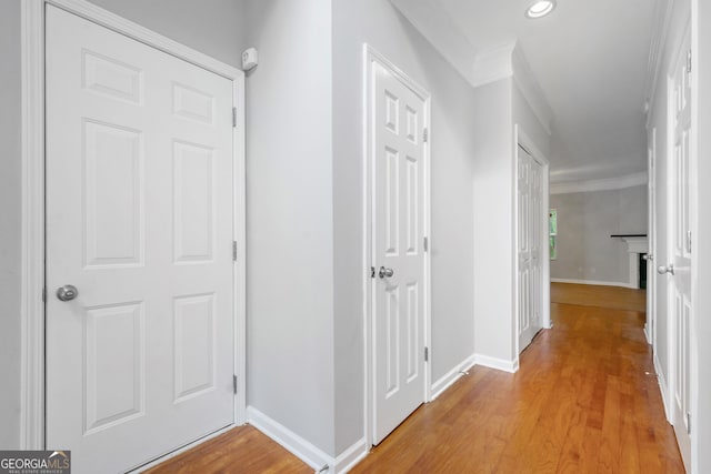 5057 Lower Elm St, Atlanta, GA 30349 - hallway with light wood finished floors, baseboards, ornamental molding, and recessed lighting