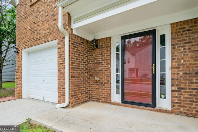 5057 Lower Elm St, Atlanta, GA 30349 - view of exterior entry featuring brick siding and a garage