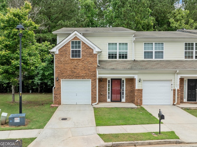 5057 Lower Elm St, Atlanta, GA 30349 - view of front of property with driveway, a garage, a front yard, and brick siding