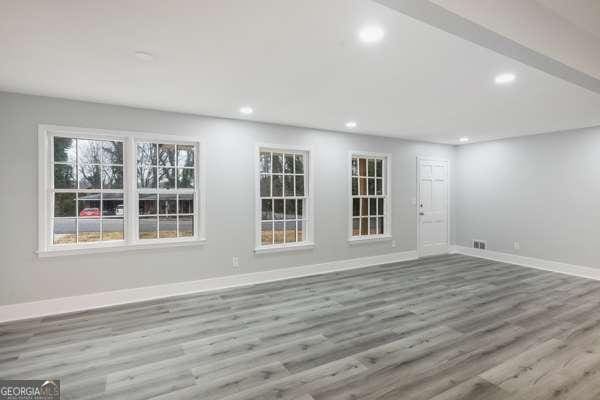 1506 Vine St NE, Gainesville, GA 30501 - spare room featuring baseboards, recessed lighting, and wood finished floors