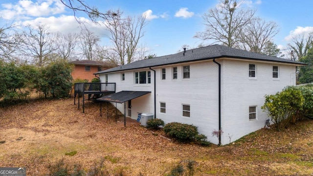 1506 Vine St NE, Gainesville, GA 30501 - rear view of house featuring a wooden deck, central AC unit, and brick siding