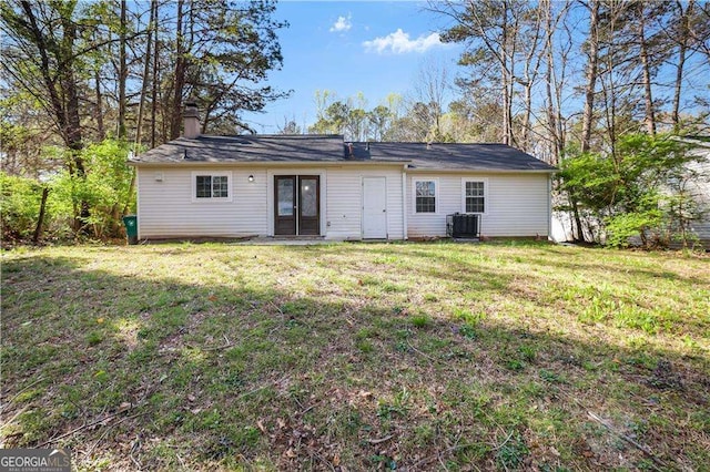 5422 Timor Trl, Lithonia, GA 30038 - rear view of house with central air condition unit, a chimney, and a yard