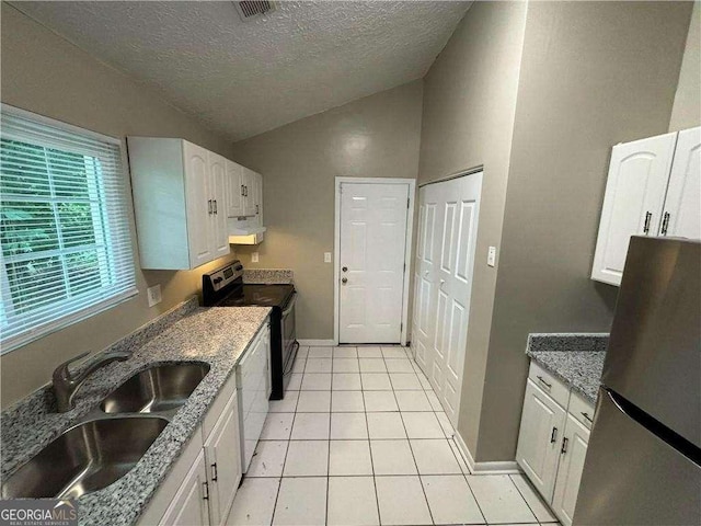 5422 Timor Trl, Lithonia, GA 30038 - kitchen with freestanding refrigerator, extractor fan, range with electric stovetop, vaulted ceiling, and a sink