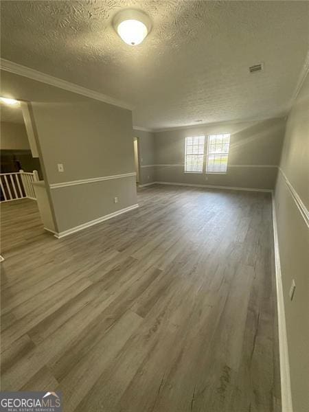 5388 Robertson Path, Lithonia, GA 30038 - spare room with a textured ceiling, wood finished floors, ornamental molding, and baseboards