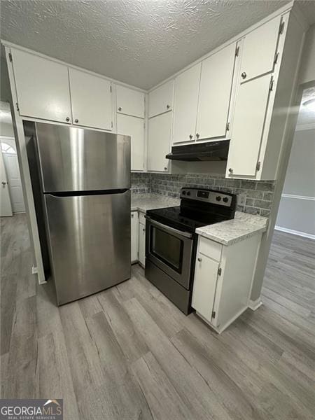 5388 Robertson Path, Lithonia, GA 30038 - kitchen featuring appliances with stainless steel finishes, under cabinet range hood, light wood finished floors, light countertops, and a textured ceiling