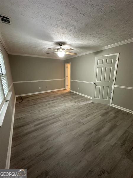 5388 Robertson Path, Lithonia, GA 30038 - empty room with a ceiling fan, a textured ceiling, dark wood-style flooring, ornamental molding, and baseboards