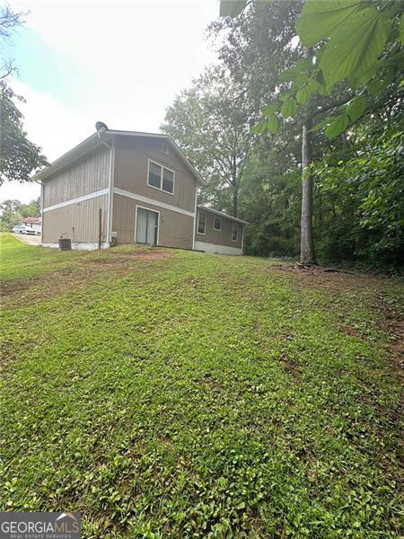 5388 Robertson Path, Lithonia, GA 30038 - back of house with a lawn