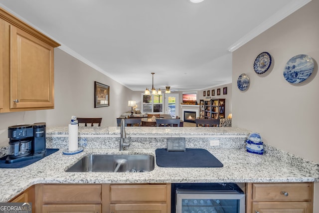 26-105 Midway Street Unit #108But Door #105, Helen, GA 30545 - kitchen featuring beverage cooler, a sink, a lit fireplace, light stone counters, and ornamental molding